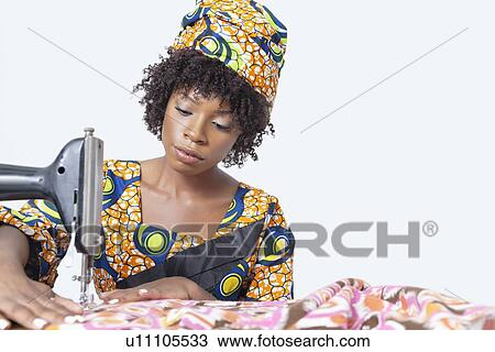 African American female fashion designer sewing fabric over gray background View Large Photo Image Stock Image - African American female fashion designer sewing fabric over gray background. Fotosearch