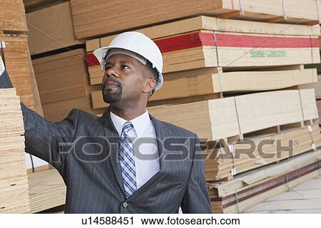 African American male engineer inspecting wooden planks View Large Photo Image Stock Image - African American male engineer inspecting wooden planks. Fotosearch