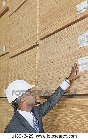 African American male engineer inspecting wooden planks View Large Photo Image Stock Photo - African American male engineer inspecting wooden planks. Fotosearch