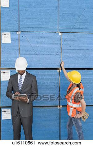 African American male engineer working on tablet PC while female industrial worker checking wooden planks View Large Photo Image Stock Image - African American male engineer working on tablet PC while female industrial worker checking wooden planks. Fotosearch