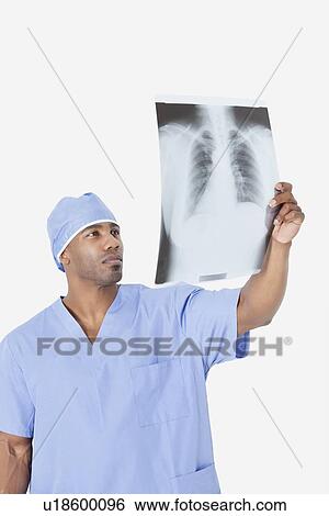 African American male surgeon analyzing x-ray report over gray background View Large Photo Image Stock Photograph - African American male surgeon analyzing x-ray report over gray background. Fotosearch