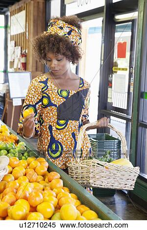 African American woman in traditional wear shopping for fruits at supermarket View Large Photo Image Stock Photography - African American woman in traditional wear shopping for fruits at supermarket. Fotosearch
