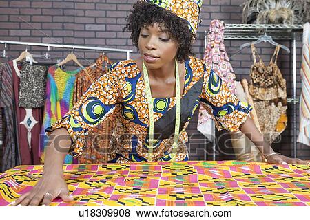 An African American female fashion designer working on a pattern cloth View Large Photo Image Stock Photo - An African American female fashion designer working on a pattern cloth. Fotosearch