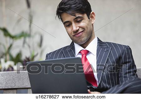 An Indian businessman using tablet PC View Large Photo Image Stock Photo - An Indian businessman using tablet PC. Fotosearch