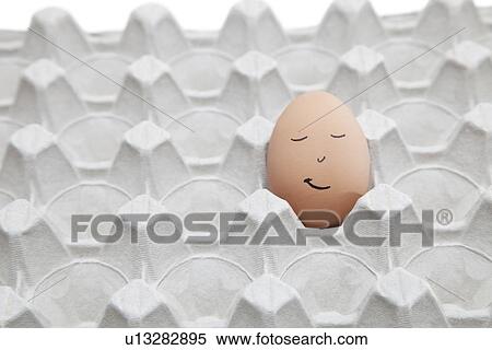 Anthropomorphic face drawn on brown egg in empty carton View Large Photo Image Stock Photography - Anthropomorphic face drawn on brown egg in empty carton. Fotosearch