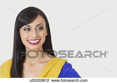 Beautiful Indian woman looking sideways over gray background View Large Photo Image Stock Image - Beautiful Indian woman looking sideways over gray background. Fotosearch