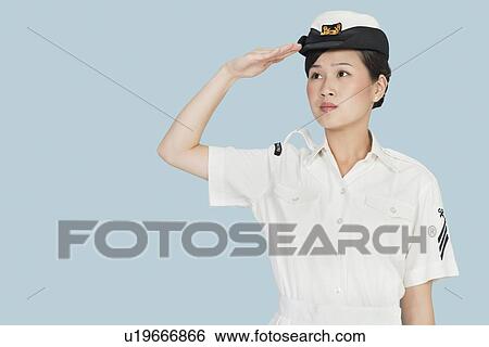 Beautiful young US Navy officer saluting over light blue background View Large Photo Image Stock Photograph - Beautiful young US Navy officer saluting over light blue background. Fotosearch
