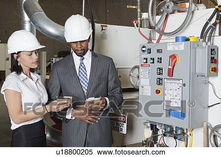 Stock Photography - Building contractors in timber factory. Fotosearch