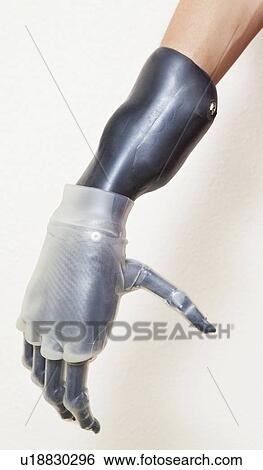 Close-up of man's prosthetic hand over gray background View Large Photo Image Stock Photograph - Close-up of man's prosthetic hand over gray background. Fotosearch