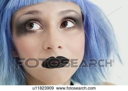 Close-up of young female punk with black lipstick, eye make-up and blue hair View Large Photo Image Stock Photo - Close-up of young female punk with black lipstick, eye make-up and blue hair. Fotosearch