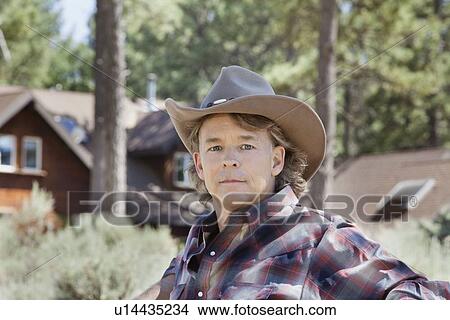 Picture - Close-up portrait of a mature man wearing cowboy hat. Fotosearch
