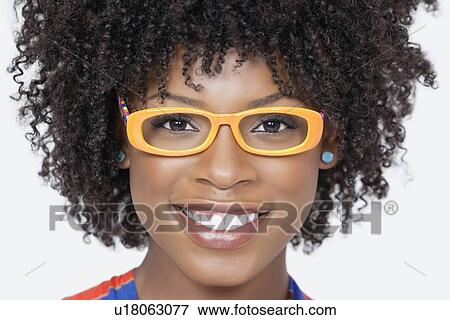 Close-up portrait of an African American woman wearing glasses over gray background View Large Photo Image Stock Photo - Close-up portrait of an African American woman wearing glasses over gray background. Fotosearch