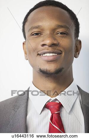 Close-up portrait of an African American businessman smiling View Large Photo Image Stock Photograph - Close-up portrait of an African American businessman smiling. Fotosearch