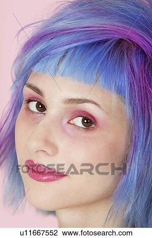 Stock Image - Close-up portrait of beautiful young woman with dyed hair. Fotosearch