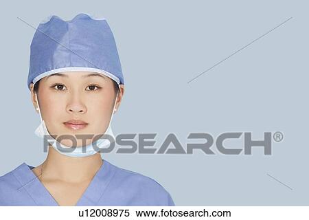 Close-up portrait of female surgeon over light blue background View Large Photo Image Stock Photography - Close-up portrait of female surgeon over light blue background. Fotosearch