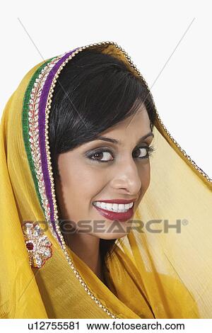 Close-up portrait of Indian woman with yellow dupatta over white background View Large Photo Image Stock Image - Close-up portrait of Indian woman with yellow dupatta over white background. Fotosearch