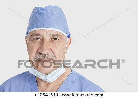 Close-up portrait of senior male surgeon over gray background View Large Photo Image Stock Photo - Close-up portrait of senior male surgeon over gray background. Fotosearch