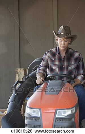 Stock Photograph - Cowboy driving utility vehicle. Fotosearch