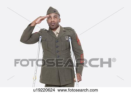 Disabled African American military officer in uniform salutes over gray background View Large Photo Image Picture - Disabled African American military officer in uniform salutes over gray background. Fotosearch