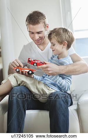 Father and son playing with toy cars View Large Photo Image Stock Photography - Father and son playing with toy cars. Fotosearch