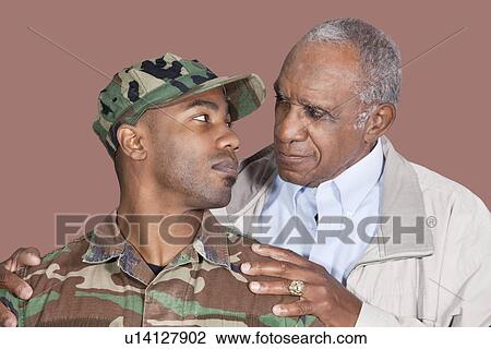 Father and US Marine Corps soldier looking at each other over brown background View Large Photo Image Stock Image - Father and US Marine Corps soldier looking at each other over brown background. Fotosearch