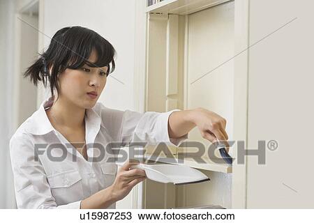 Female housekeeper cleaning shelf View Large Photo Image Stock Image - Female housekeeper cleaning shelf. Fotosearch