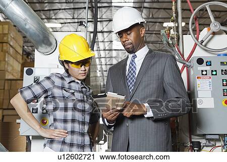 Female industrial worker and male engineer in discussion at timber factory View Large Photo Image Stock Image - Female industrial worker and male engineer in discussion at timber factory. Fotosearch