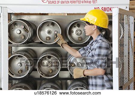 Female industrial worker taking out propane cylinder View Large Photo Image Stock Photograph - Female industrial worker taking out propane cylinder. Fotosearch