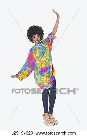 Full length portrait of happy African American woman in dashiki dancing over gray background View Large Photo Image Stock Image - Full length portrait of happy African American woman in dashiki dancing over gray background. Fotosearch