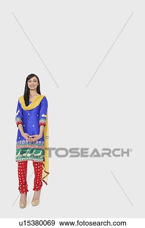 Full length portrait of Indian woman in traditional wear standing over gray background View Large Photo Image Stock Photo - Full length portrait of Indian woman in traditional wear standing over gray background. Fotosearch