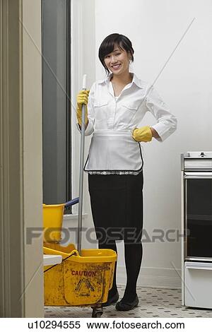 Full length portrait of young maidservant with mop and bucket View Large Photo Image Stock Photography - Full length portrait of young maidservant with mop and bucket. Fotosearch