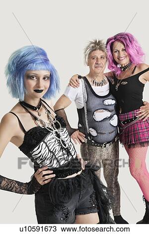 Group portrait of young female punk with senior couple standing in background View Large Photo Image Stock Image - Group portrait of young female punk with senior couple standing in background. Fotosearch