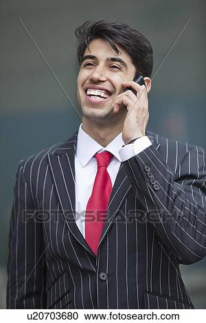 Happy Indian businessman communicating on cell phone View Large Photo Image Stock Image - Happy Indian businessman communicating on cell phone. Fotosearch