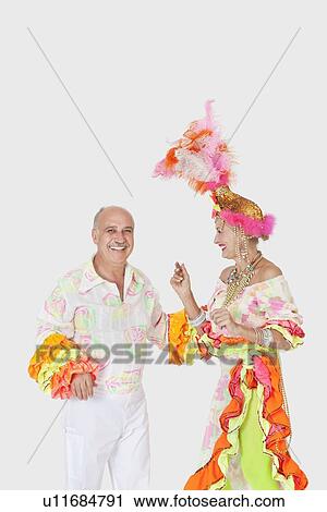 Happy senior dancing couple in Brazilian outfits dancing over gray background View Large Photo Image Stock Image - Happy senior dancing couple in Brazilian outfits dancing over gray background. Fotosearch