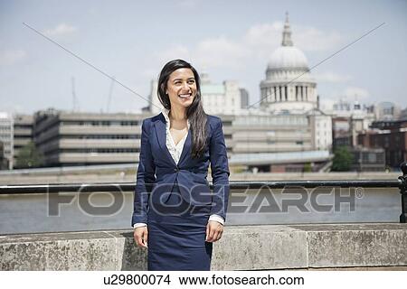 Happy young Indian businesswoman with St. Paul's Cathedral in background View Large Photo Image Picture - Happy young Indian businesswoman with St. Paul's Cathedral in background. Fotosearch