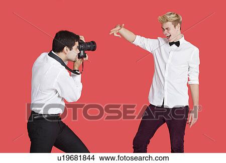 Male actor being photographed by paparazzi over red background View Large Photo Image Picture - Male actor being photographed by paparazzi over red background. Fotosearch