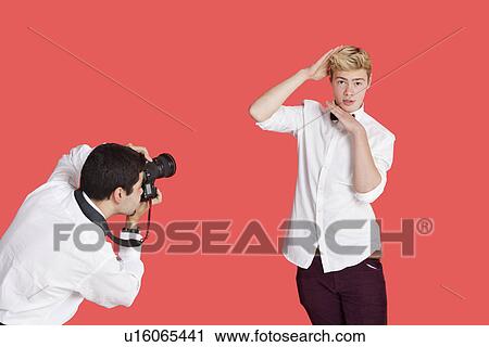 Male actor being photographed by paparazzi over red background View Large Photo Image Stock Image - Male actor being photographed by paparazzi over red background. Fotosearch
