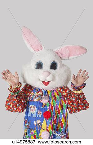 Man wearing bunny mask with standing raised hands against gray background View Large Photo Image Stock Photo - Man wearing bunny mask with standing raised hands against gray background. Fotosearch