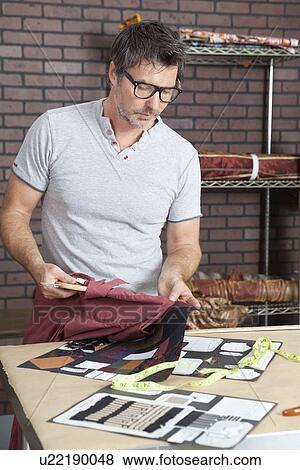 Mature male fashion designer matching color of shirt with cloth swatch View Large Photo Image Stock Photo - Mature male fashion designer matching color of shirt with cloth swatch. Fotosearch