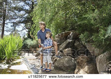 Mature man with son fishing at lake View Large Photo Image Stock Photo - Mature man with son fishing at lake. Fotosearch