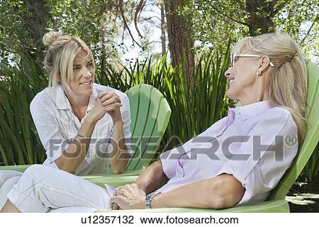 Stock Image - Mature woman and mother having a quality time at park. Fotosearch