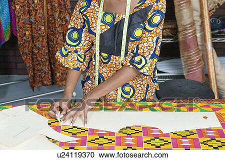 Midsection of female fashion designer tracing pattern on cloth with chalk View Large Photo Image Stock Image - Midsection of female fashion designer tracing pattern on cloth with chalk. Fotosearch