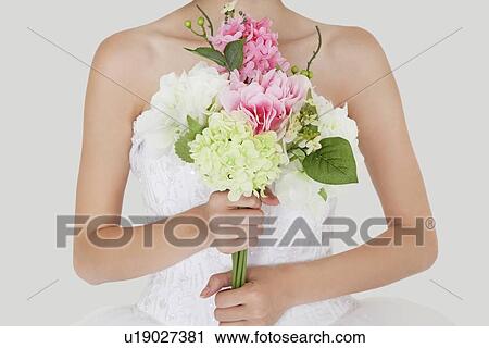 Midsection of young bride holding fresh bouquet View Large Photo Image Stock Image - Midsection of young bride holding fresh bouquet. Fotosearch