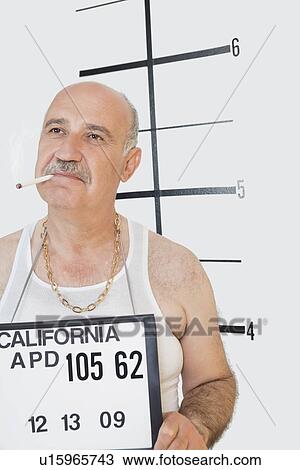 Mug shot of senior male smoking cigarette View Large Photo Image Stock Image - Mug shot of senior male smoking cigarette. Fotosearch