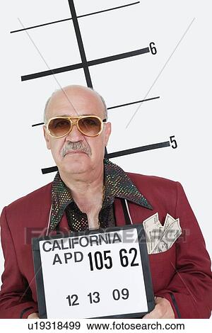 Stock Photo - Mug shot of senior man wearing sunglasses and banknotes in pocket. Fotosearch
