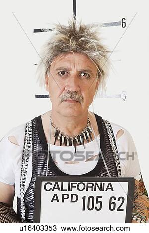 Stock Image - Mug shot of serious senior male punk. Fotosearch