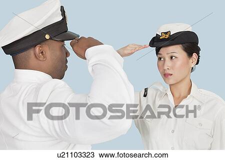Multi-ethnic US Navy officers saluting each other over light blue background View Large Photo Image Stock Image - Multi-ethnic US Navy officers saluting each other over light blue background. Fotosearch