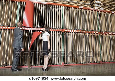 Picture - Multiethnic business coworkers selecting thin red veneer sheets. Fotosearch