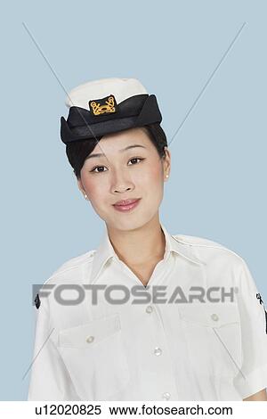 Portrait of a beautiful young US Navy officer over light blue background View Large Photo Image Stock Photography - Portrait of a beautiful young US Navy officer over light blue background. Fotosearch
