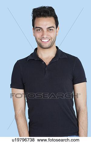 Stock Photo - Portrait of a handsome man smiling over blue background. Fotosearch